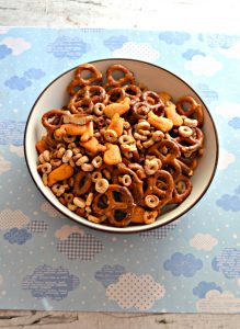 A bowl of party mix with Cheerios