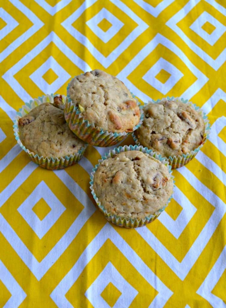 4 hummingbird muffins stacked on a yellow and white placemat