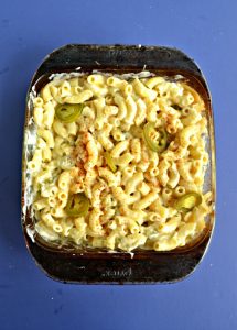 A glass pan of macaroni and cheese with jalapenos