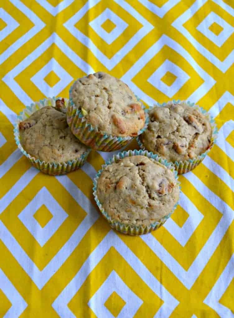 Four sourdough hummingbird muffins on a yellow placemat