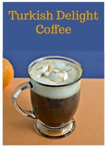 Pin Image: Text overlay over a clear coffee mug filled two thirds of the way with coffee then topped with fresh whipped cream and bits of orange zest.
