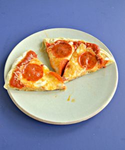 A plate with 3 slices of pepperoni pizza on a blue background.