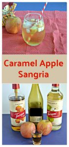 Pin Image: A stemless glass of Caramel Apple Sangria with apple pieces floating in it with a straw sticking out of it on a red background with a scarecrow holding and apple behind the beverage, text overlay, a bottle of caramel syrup, a bottle of wine, a bottle of green apple syrup, and two apples in front of it.