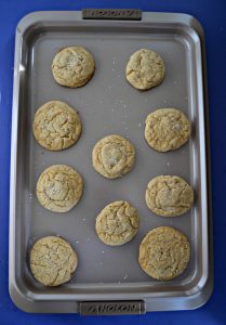 A cookie ssheet with baked cookies arranged on it.