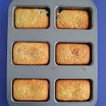 A mini loaf pan with six golden brown mini breads.