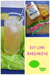 Pin Image: A glass of key lime margarita on the rocks with a lime wedge and salt on the rim and a straw in the glass, a cutting board with a bag of sugar on it, a bottle of tequila, and a bag of key limes, text.