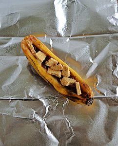 A banana stuffed with chocolate chips and graham cracker pieces.