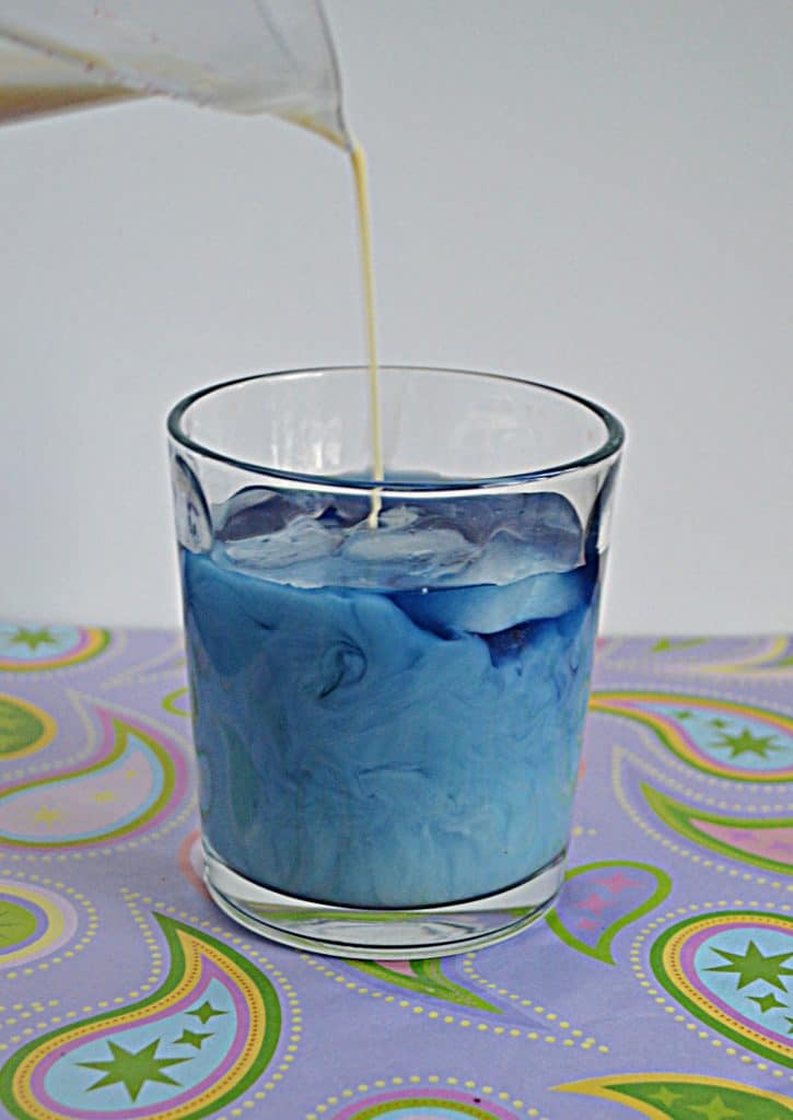 A glass of light blue Butterfly Pea Flower Iced Tea Latte