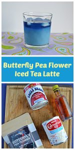 Pin Image: A glass of light blue Butterfly Pea Flower Iced Tea Latte, text, a cutting board with a bag of tea bags, a can of sweetened condensed milk, a can of evaporated milk, and a bottle of vanilla.