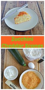 Pin Image: A plate with a giant Zucchini Cheddar scones with a knife on the plate, text, cutting board with a zucchini on it, a bowl of cheddar cheese, a cup of flour, an egg, a stick of butter, and baking powder.