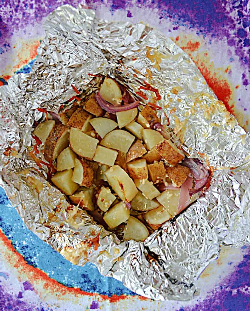 A foil packet filled with cooked potatoes, onions, and cheese. 