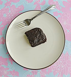 A plate with a chocolate Sourdough Brownie on it along with a fork.