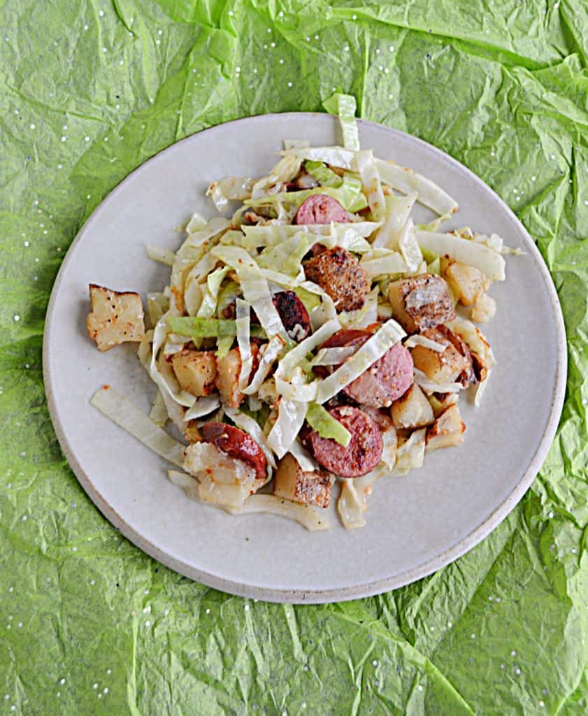 A plate piled with cabbage, kielbasa, and potatoes. 
