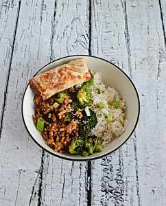 A bowl with Honey Srirach Chicken, Broccoli, and Rice