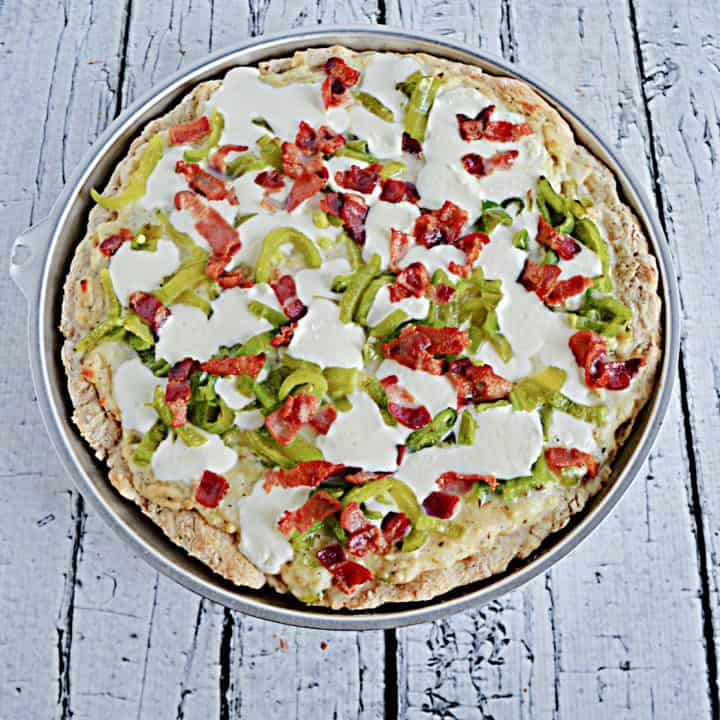 A Hatch Chile Pizza topped with Mozzarella, bacon,a nd roasted Hatch Chiles.