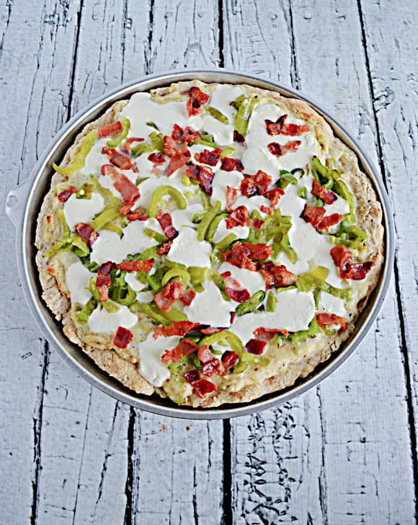 A Hatch Chile Pizza topped with Mozzarella, bacon,a nd roasted Hatch Chiles.