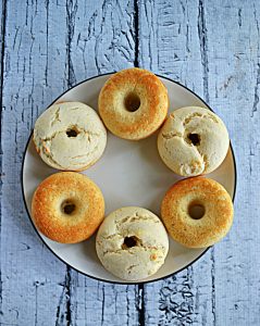 A plate of 6 vanilla donuts.
