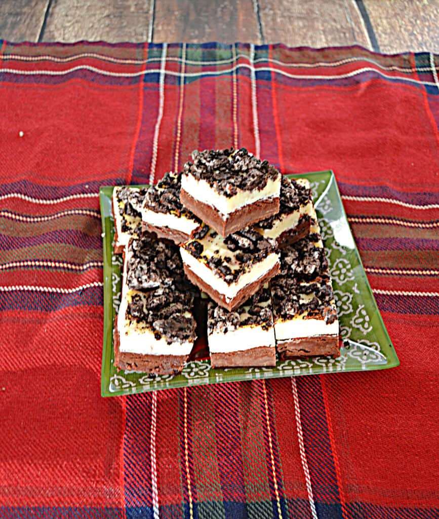 A plate stacked with candy cane cookie fudge squares