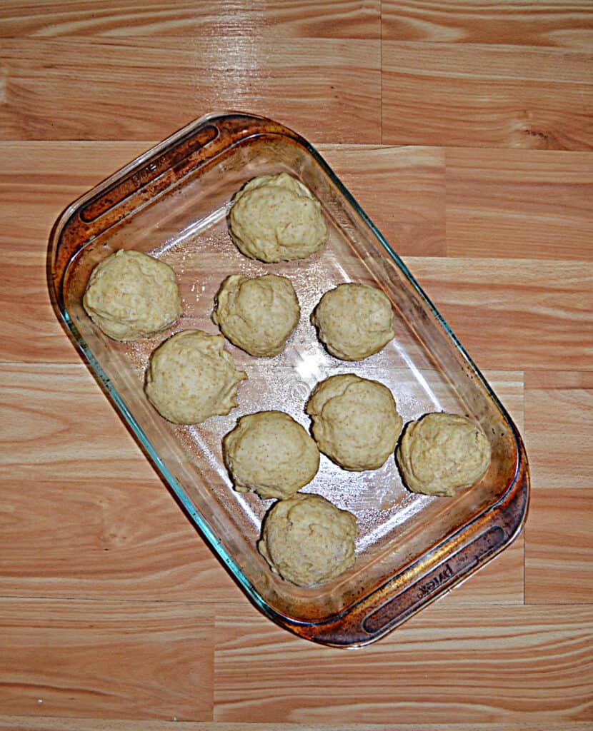 A baking pan with unbaked sourdough rolls.