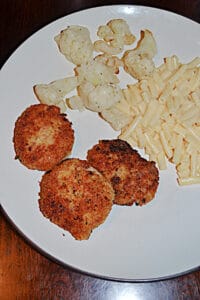 A plate with 3 Tuna Croquettes, a scoop of mac n cheese, and cauliflower.