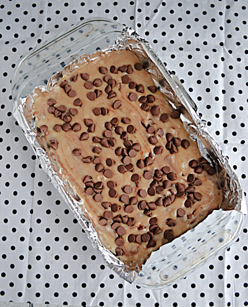 A pan of chocolate chip cookie dough fudge with chocolate chips.