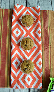 Three Carrot Cake Cupcakes on an orange towel.