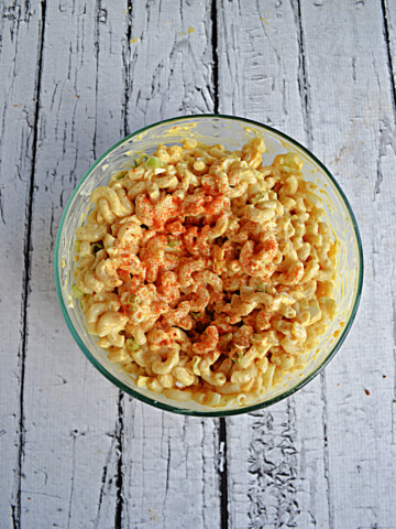 A bowl of Deviled Egg Macaoni Salad with paprika on top.