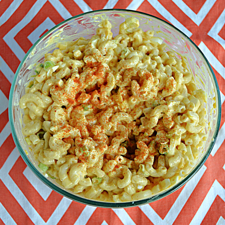 A close up view of a bowl of Deviled Egg Pasta Salad with paprkia on top.