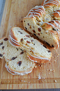 A close up of two slices of rum raisin bread and the loaf of bread.