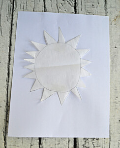 A parchment sun on a sheet of paper.