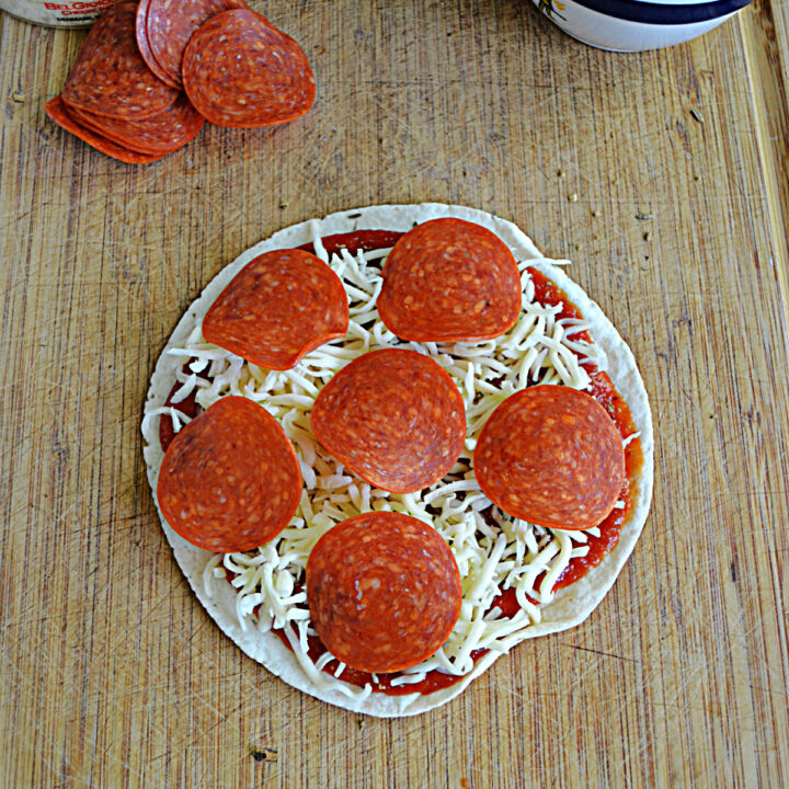 A tortilla pizza topped with mozzarella and pepperoni.