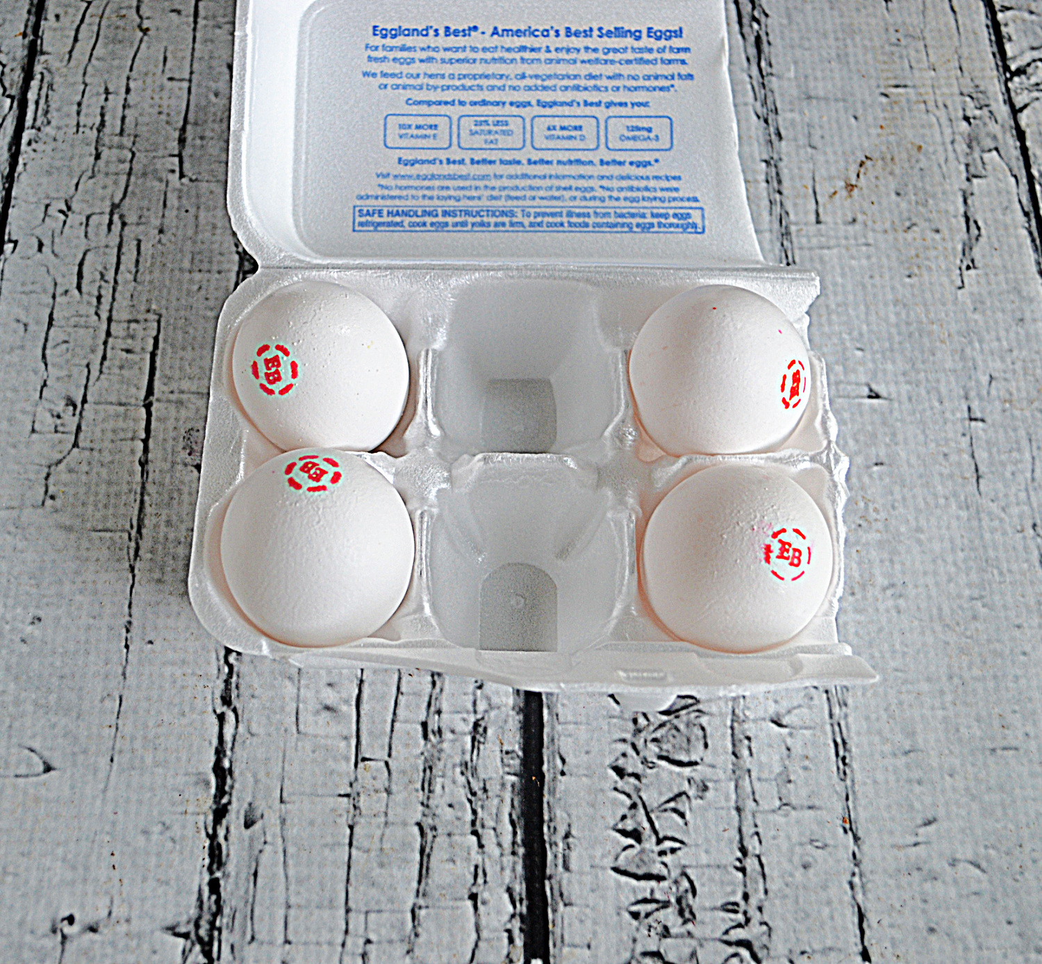 A container with 4 eggs in it. 