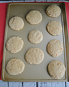 A cookie sheet with graham cracker cookies on top.