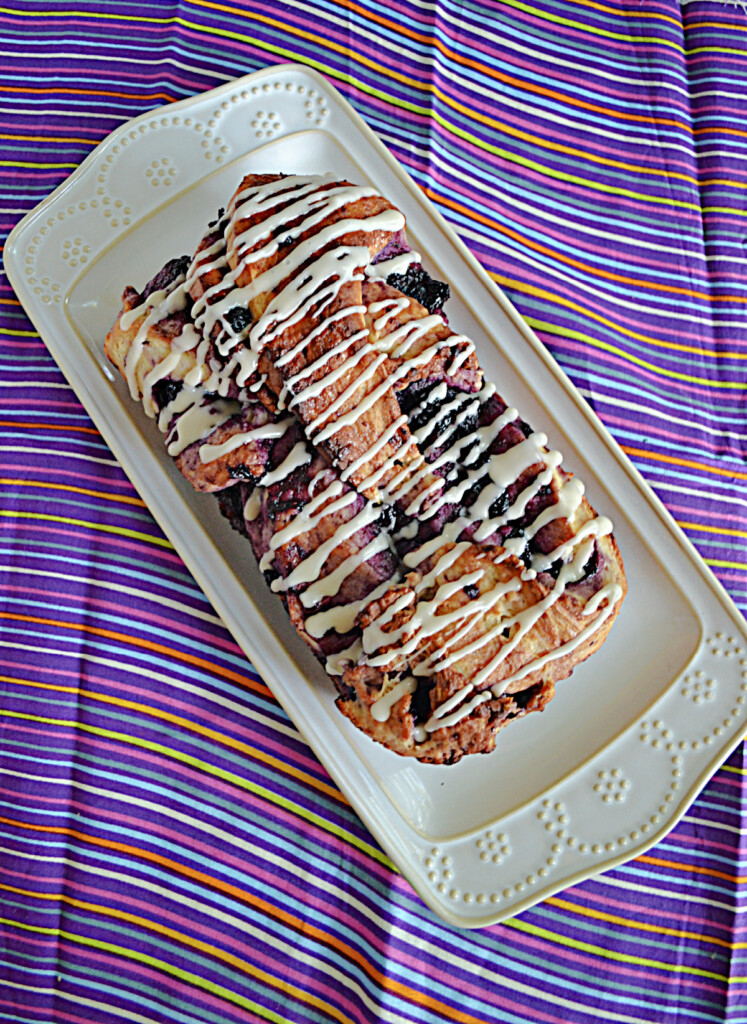 A top view of a Blueberry Babka with vanilla glaze on top.