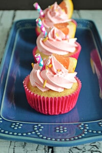 A close up of a pink grapefruit cupcake.