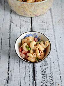 A small bowl with macaroni salad in it.