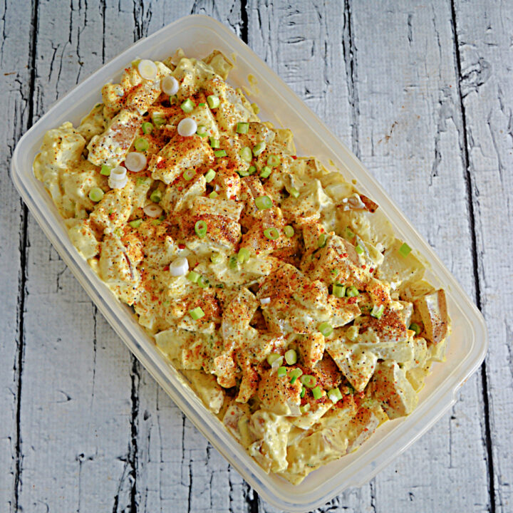 A container filled with potato salad.