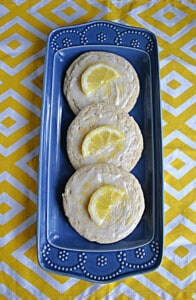 A platter with 3 lemon cookies on it.