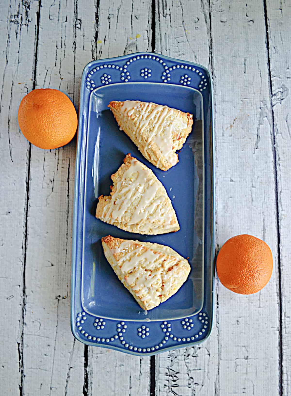 A platter of scones and oranges.