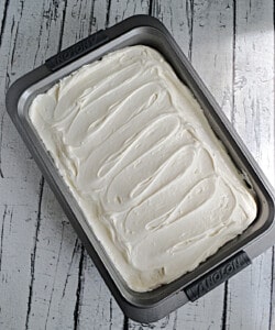 A cake with whipped cream frosting.