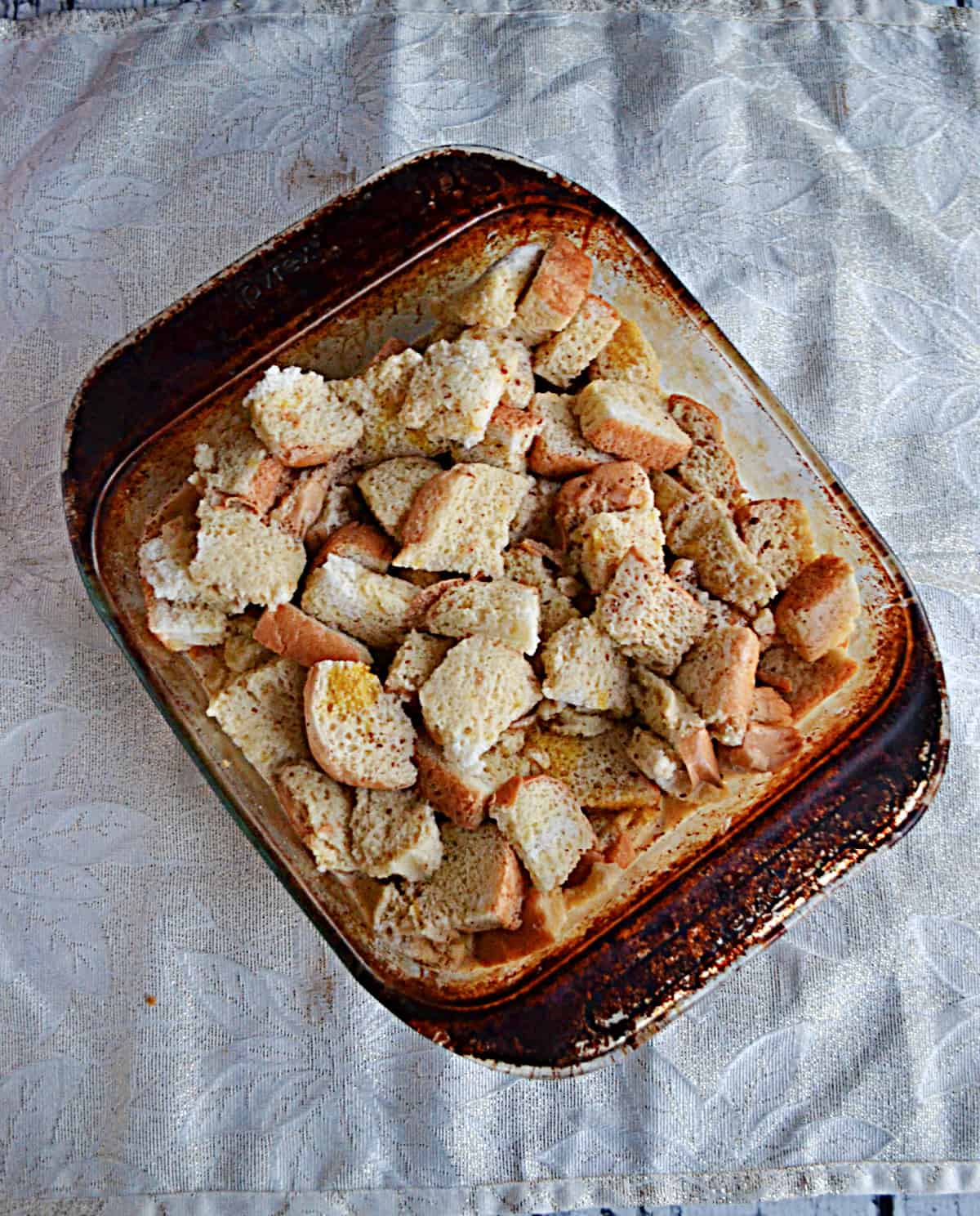 A baking dish with cut up pieces of bread.