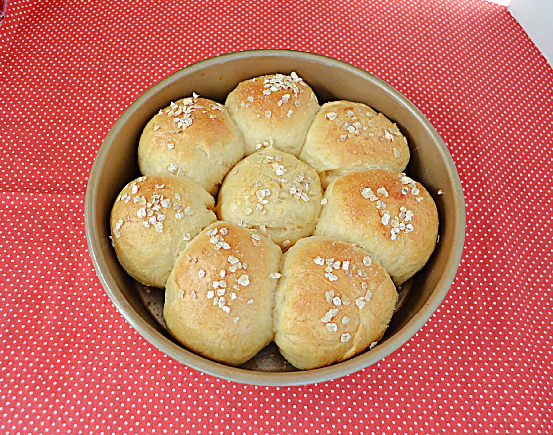 A pan with golden brown rolls in it.