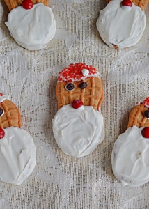A close up of a Santa Claus cookie made out of a Nutter Butter