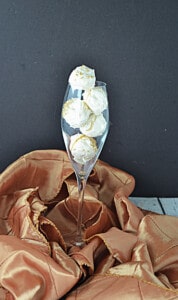 A champagne flute filled with champagne truffles.