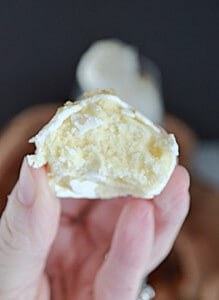 A close up of the inside of the champagne truffle being held by a hand.