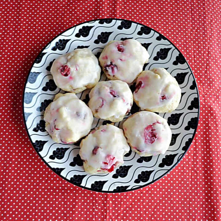 A plate with seven Lemon Cranberry Cookies on it.