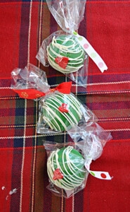Three wrapped Grinch Hot Cocoa Bombs