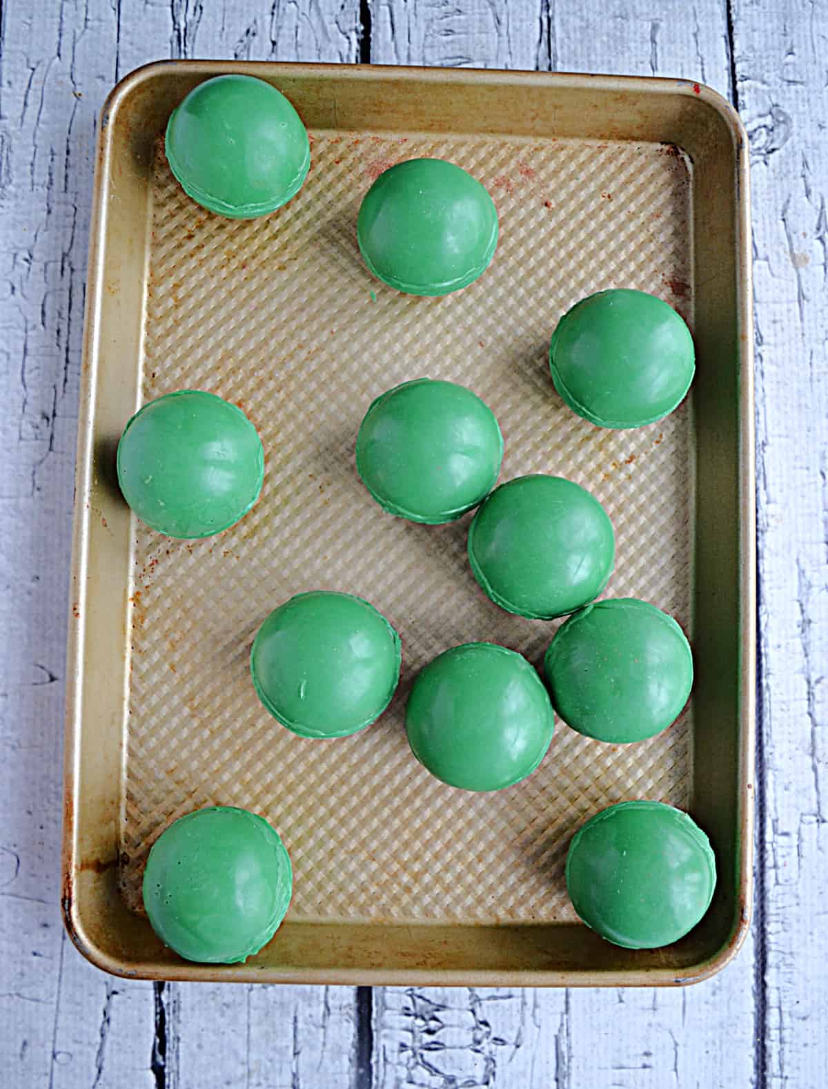 A tray of green hot cocoa bombs.