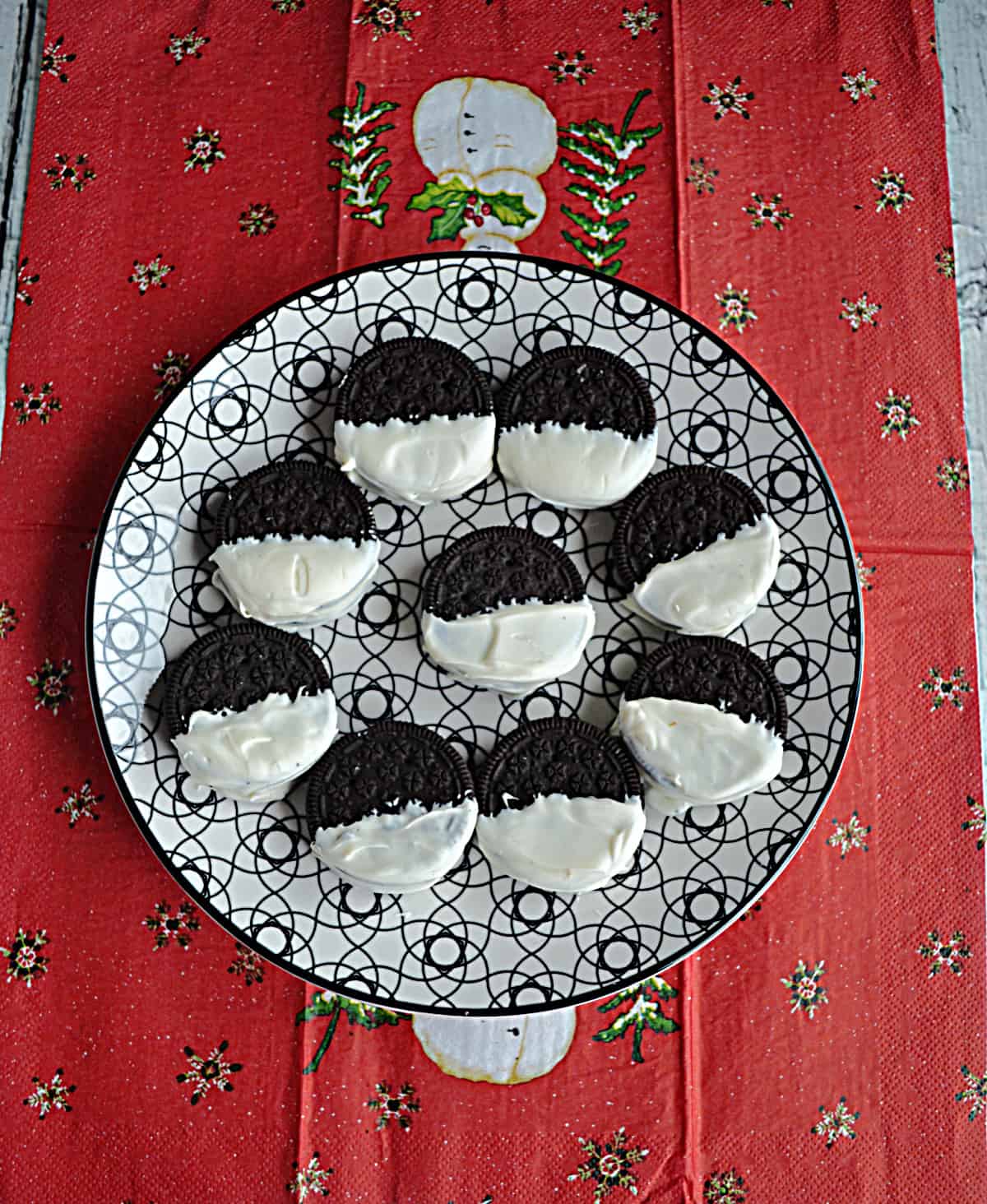 A plate of Oreos dipped in white chocolate.