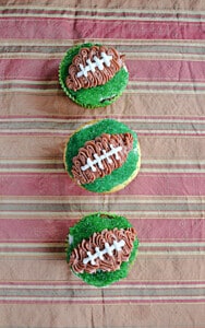 Three cupcakes with a football design on them.